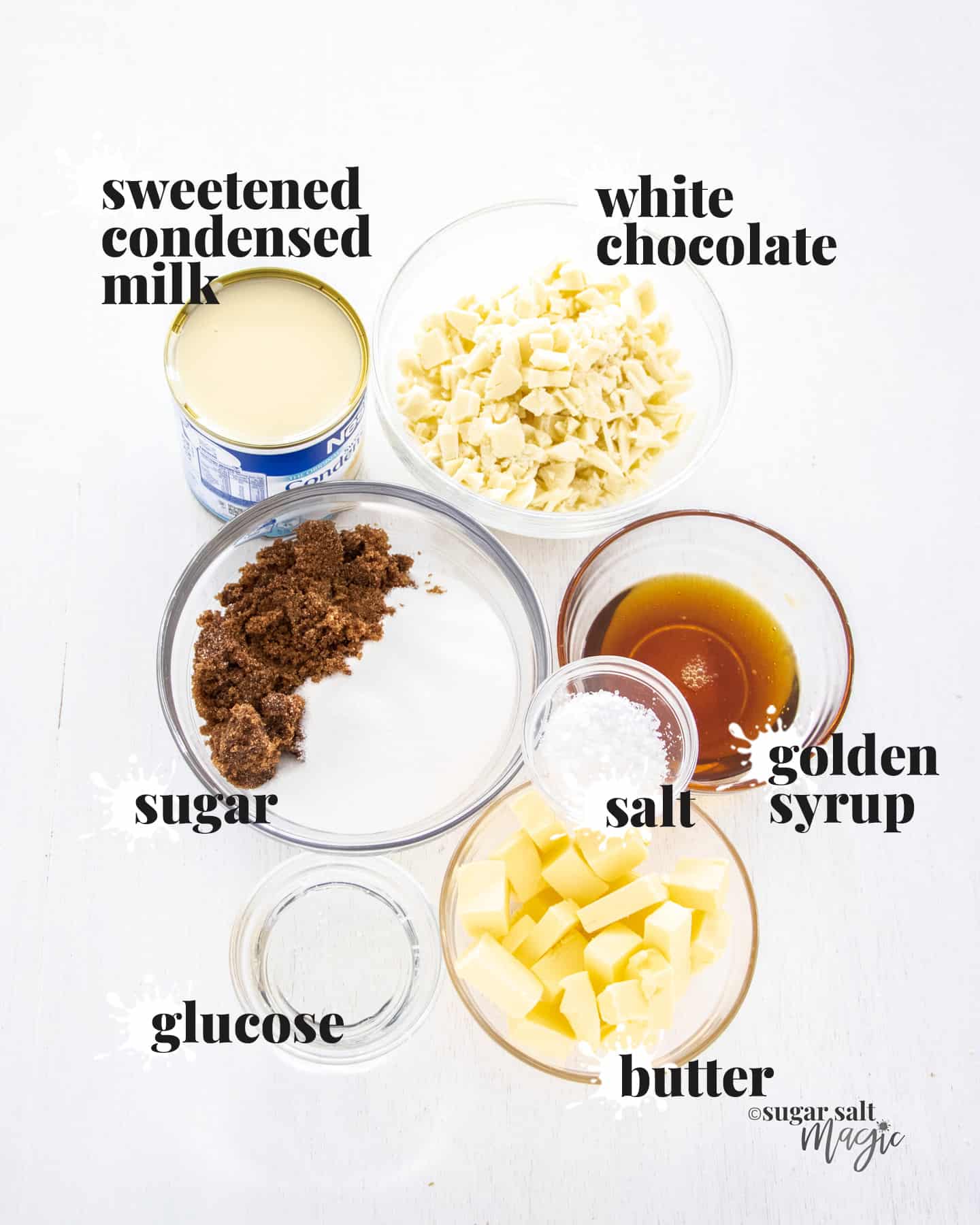 Ingredients for salted caramel fudge laid out on a white wooden board.