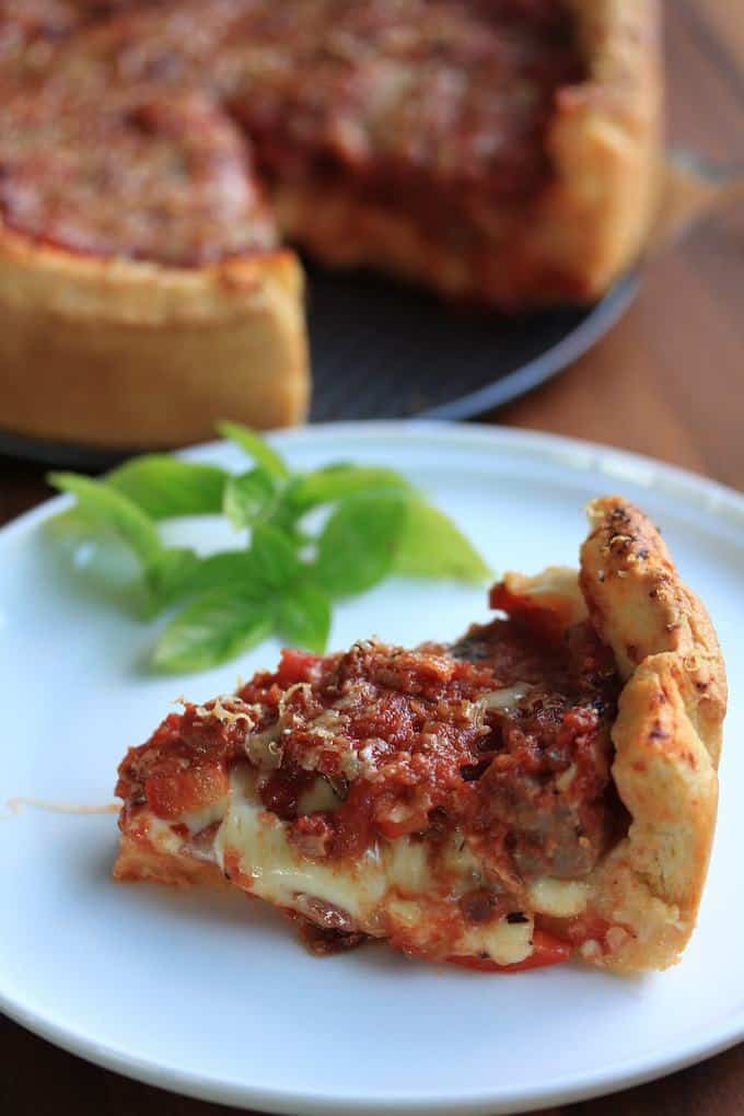 A slice of Chicago deep dish pizza on a plate.