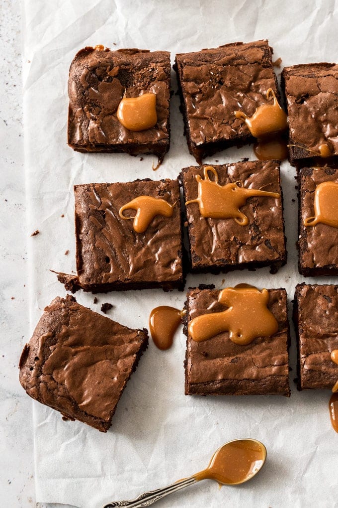 Overhead view of brownie squares topped with caramel sauce