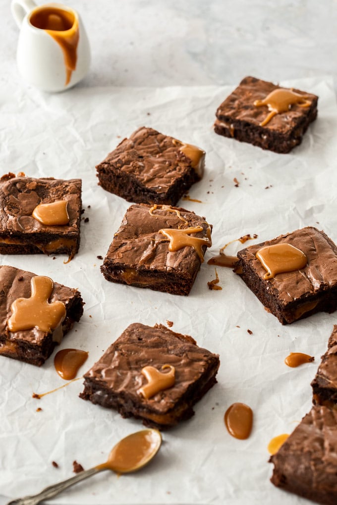 Squares of brownies drizzled with caramel sauce in random positions 
