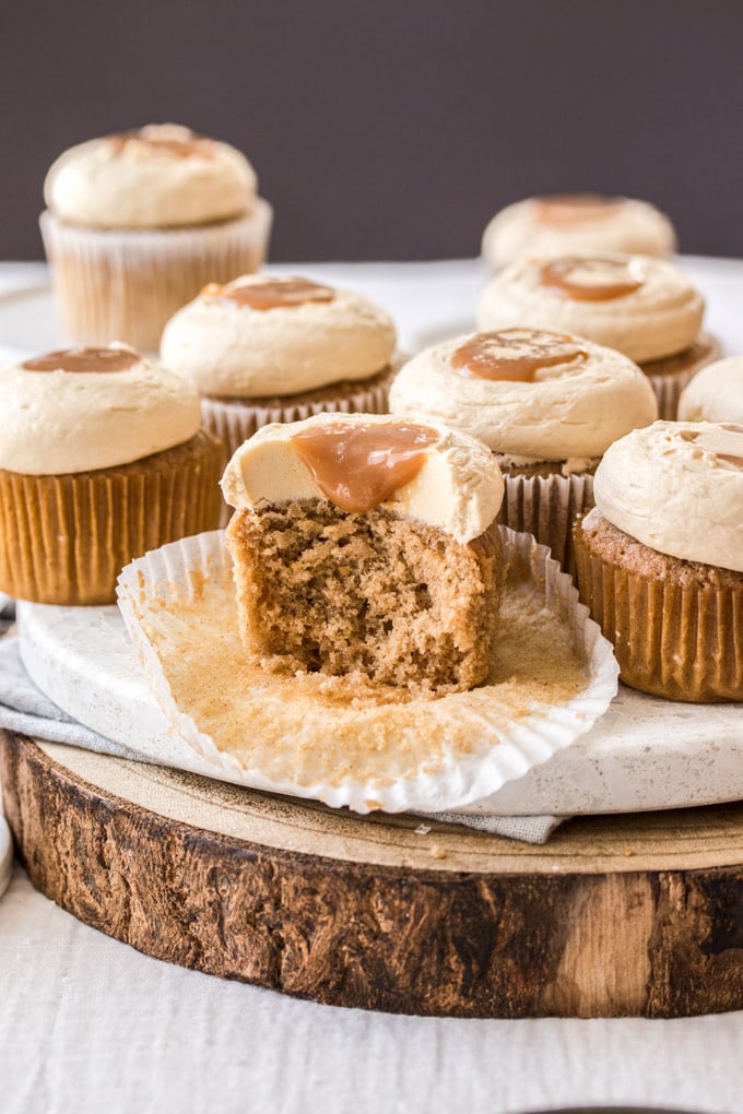 A cinnamon cupcake cut open showing the centre, more cupcakes in the back