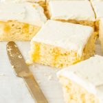 This Almond Lemon Poke Cake, filled with lemon curd and topped with an easy ricotta cream topping, is incredibly easy to make. Made in a sheet pan so it’s easy to slice and serve too.