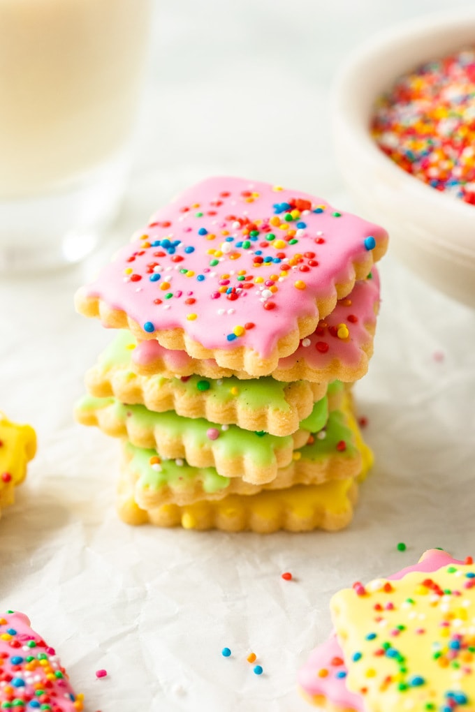 A stack of colourful cookies covered in sprinkles
