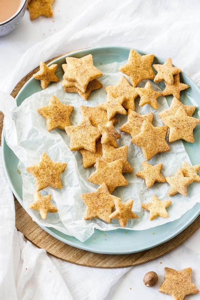 Birdseye view of a pastel green plate topped with star-shaped shortbread cookies