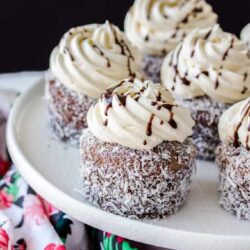 Lamington Cupcakes are those traditional little aussie cakes turned into a cupcake. A soft, fluffy vanilla cupcake, filled with jam and covered with an easy chocolate glaze and coconut.