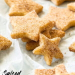 Closeup of a stack of star-shaped shortbread cookies on a sheet of crumpled baking paper