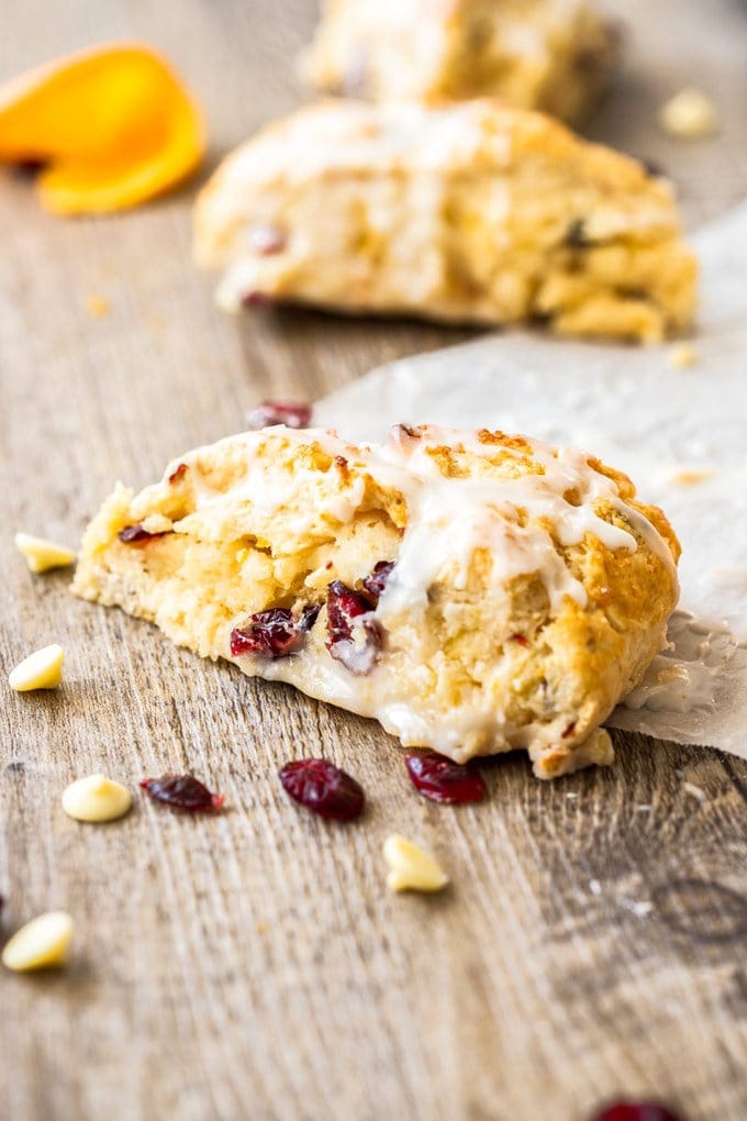 Closeup of a cranberry scone sitting on a wooden board