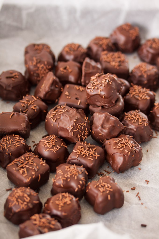 A batch of chocolate butterscotch candies on a sheet of baking paper.