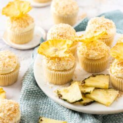 A batch of cupcakes with pineapple flowers on top