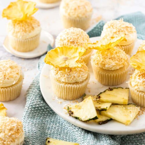 A batch of cupcakes with pineapple flowers on top