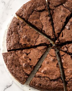 Top down view of 8 slices of brownie pie on a white marble platter