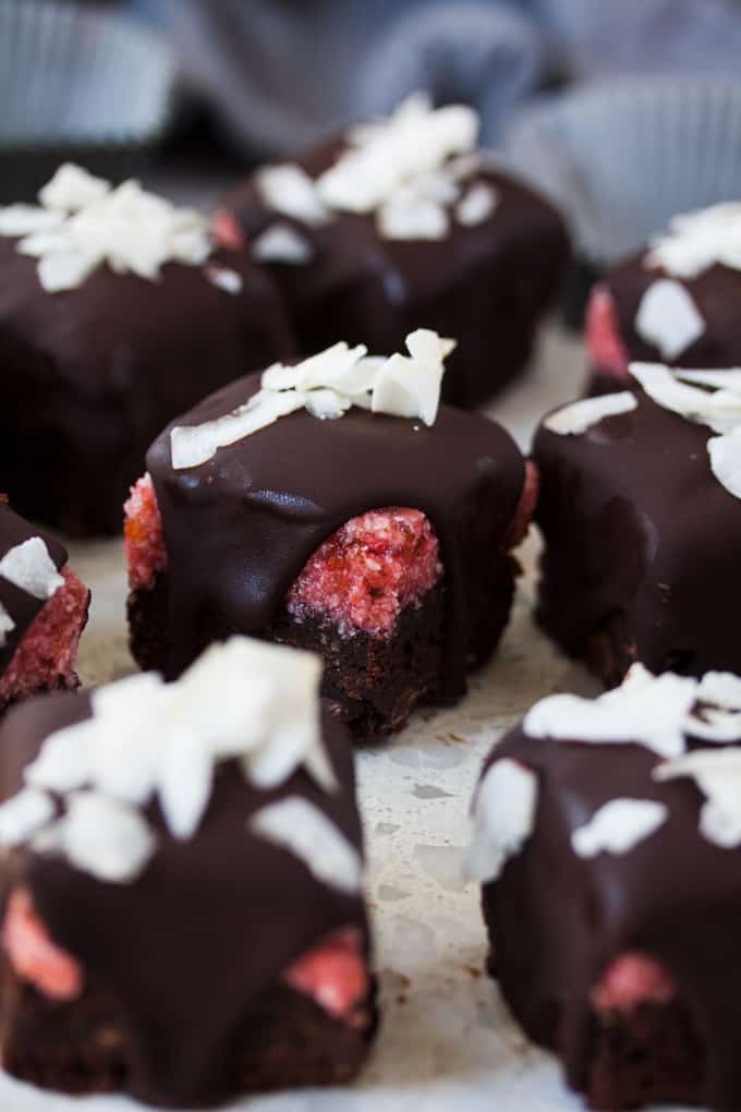 Closeup of a cherry ripe brownie covered in chocolate with coconut on top