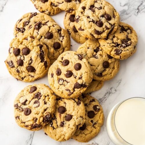 A pile of chocolate chip cookies on a marble bench top
