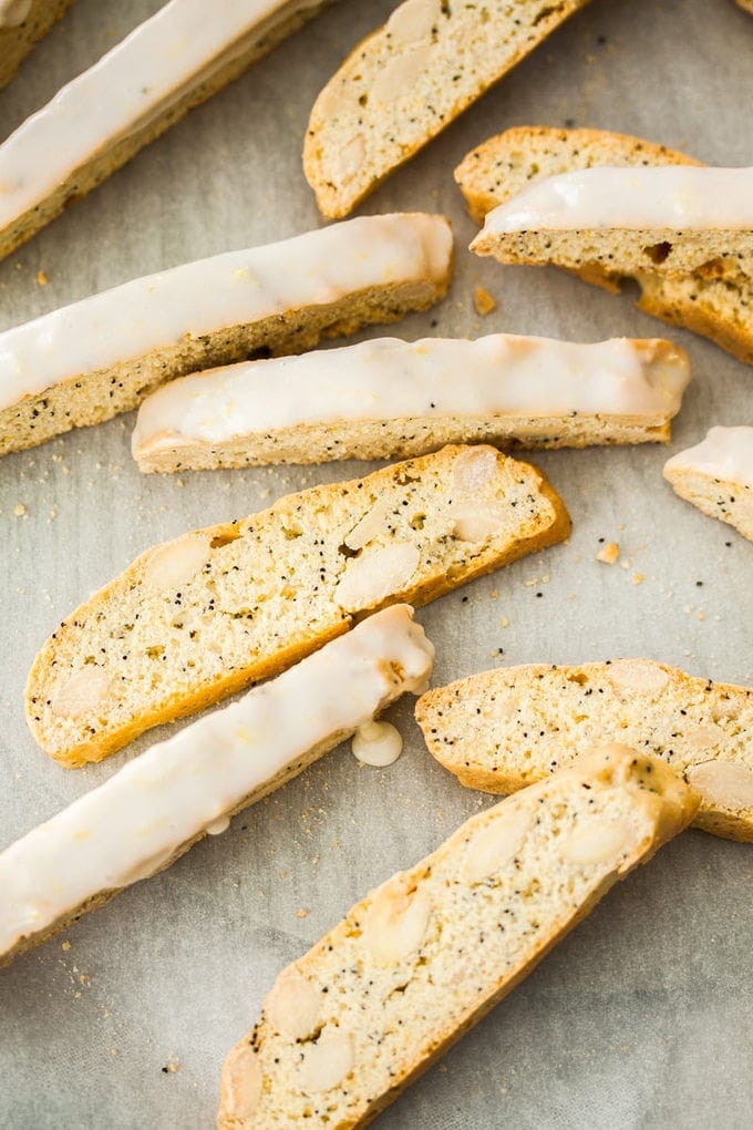 A group of biscotti slices sitting on a sheet of baking paper.