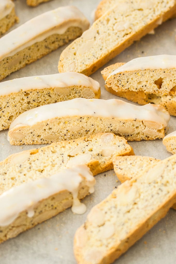 A group of lemon almond biscotti on a sheet of baking paper.
