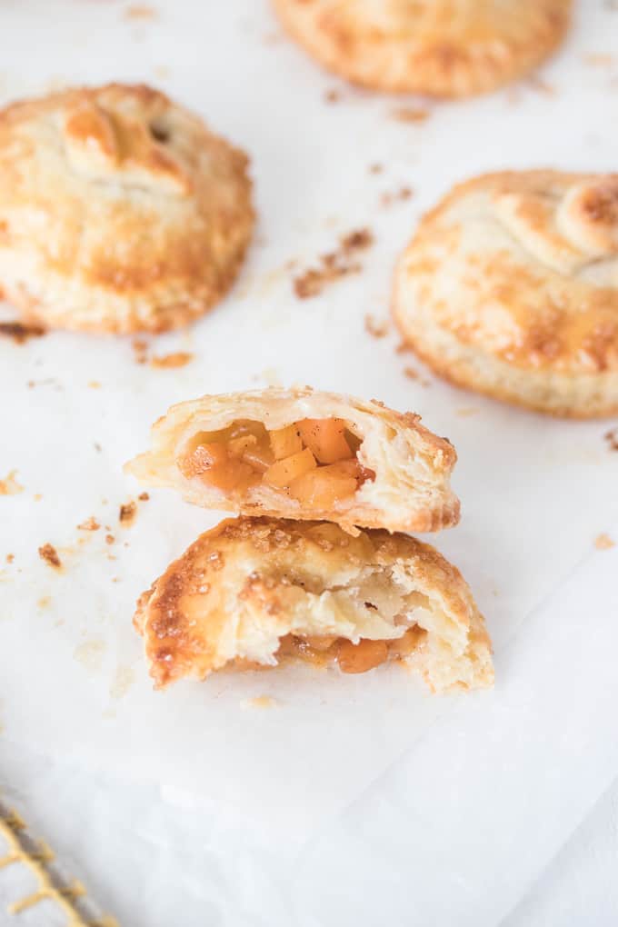 These Spiced Peach Hand Pies are a combination of fresh peaches, a kick of cinnamon and ginger, all wrapped up in the perfect buttery pie crust. These mini pies are the perfect portable dessert.