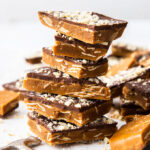 A pile of almond roca buttercrunch toffee covered in chocolate and almonds