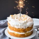 This Lemon Meringue Cake is a simple layered cake, filled with homemade lemon curd and whipped cream and topped with a cloud-like meringue. It makes a dramatic and gorgeous celebration cake.