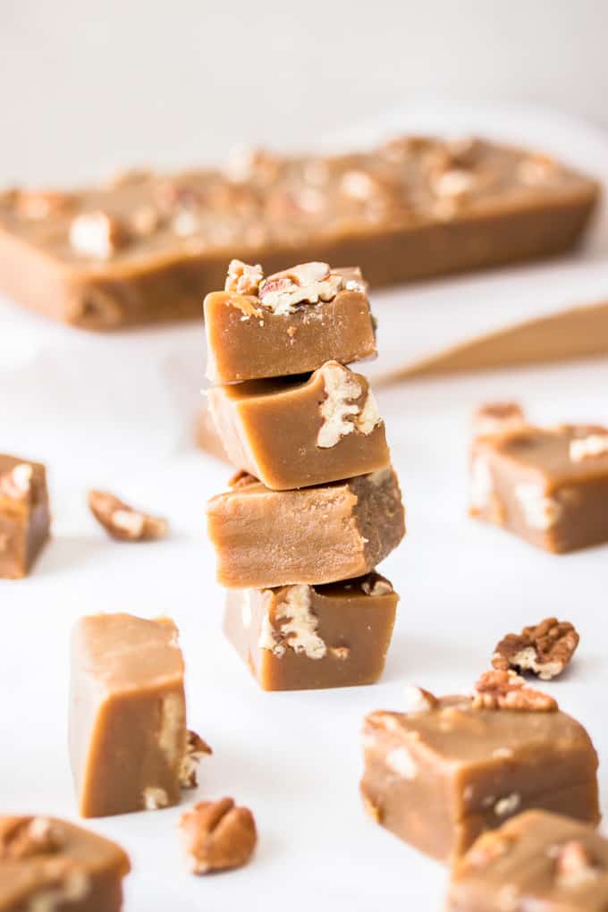 A stack of pecan fudge squares surrounded by more