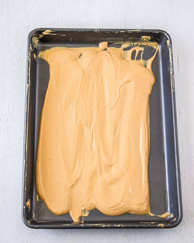 A baking tin covered in caramelised white chocolate.