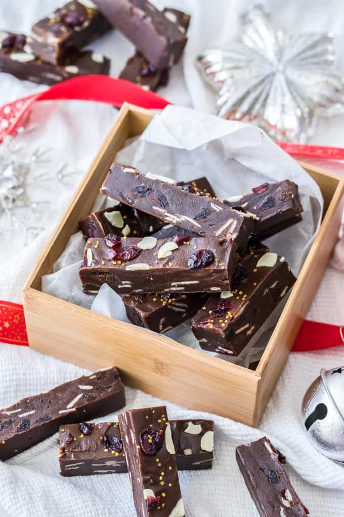 A wooden box filled with Christmas Fudge, slices of fudge scattered around.