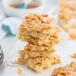 This Honey Almond Slice is an easy shortbread base topped with flaked almonds that have been mixed with a honey butter mixture. It bakes up crispy and chewy and will leave you wanting more. #sugarsaltmagic #honeyalmond #honeyalmondslice #shortbreadslice #almondshortbread #shortbreadrecipe #recipe #shortbread #almond #honeyjoys
