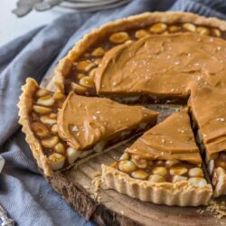 This Macadamia Salted Caramel Tart recipe is a showstopper. A real salted caramel tart filling wrapped around macadamia nuts and topped with a caramelised white chocolate ganache