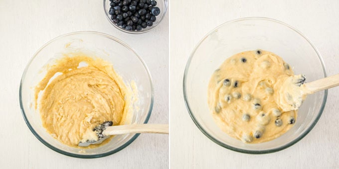 Folding blueberries into muffin batter in a glass mixing bowl with a spatula