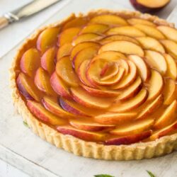 This Panna Cotta Fresh Peach Tart is delicate layers of cream cheese panna cotta, fresh peach slices and homemade peach jelly In a perfect tart shell.