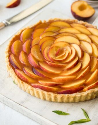 This Panna Cotta Fresh Peach Tart is delicate layers of cream cheese panna cotta, fresh peach slices and homemade peach jelly In a perfect tart shell.