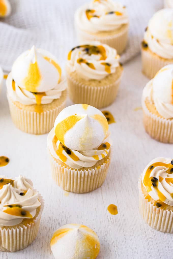 Passionfruit Coconut Cupcakes topped with yellow and white meringue.