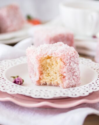 This Rose Strawberry Lamington recipe is a lovely twist on the classic Aussie Lamington. Pink lamingtons with a fluffy sponge centre and a homemade rose and strawberry jelly.