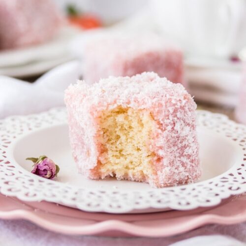This Rose Strawberry Lamington recipe is a lovely twist on the classic Aussie Lamington. Pink lamingtons with a fluffy sponge centre and a homemade rose and strawberry jelly.