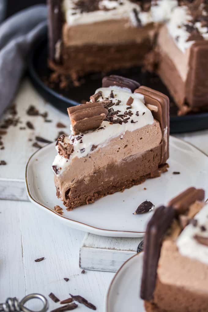 Closeup of a slice of No Bake Tim Tam Cheesecake on a white plate