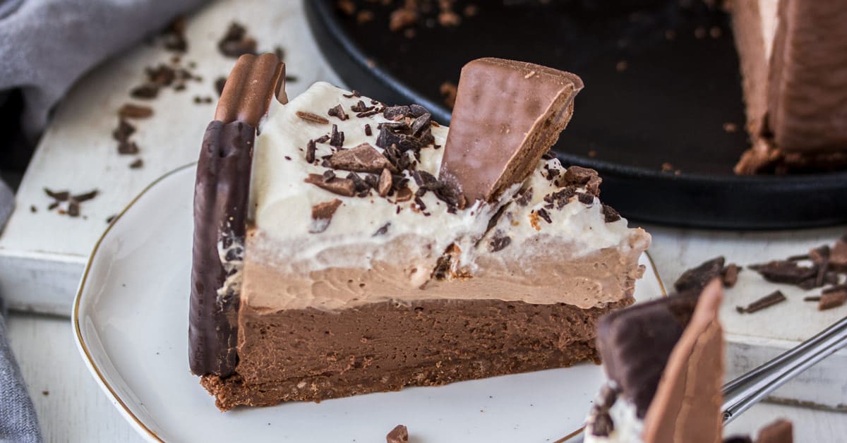 A slice of no bake Tim Tam cheesecake on a white plate