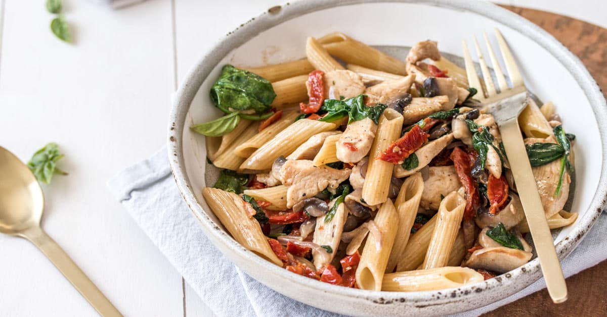 A bowl filled with chicken penne pasta 