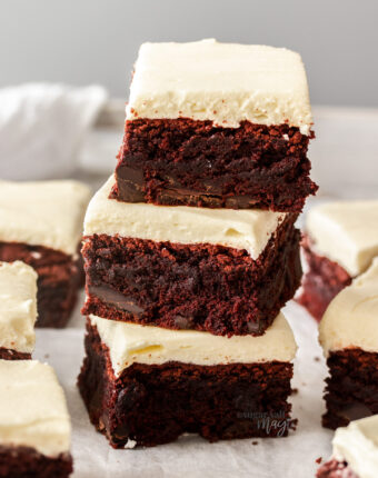 A stack of 3 red velvet brownies with more around it