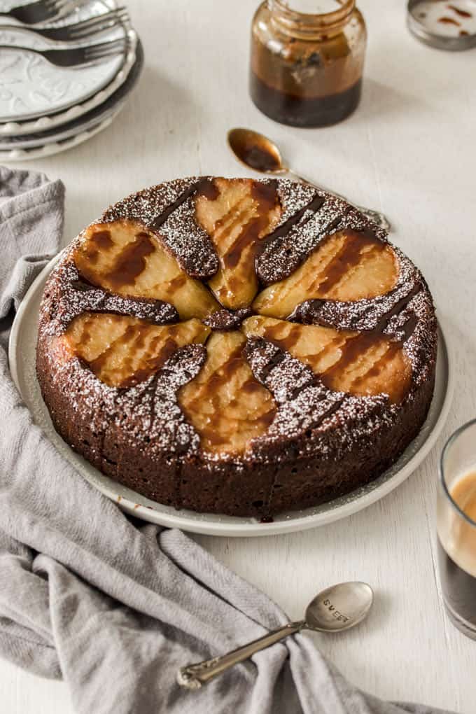 A whole Chocolate Pear Upside Down Cake on a serving plate
