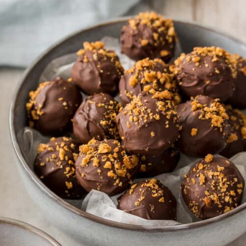 Chocolate truffles in a grey bowl.