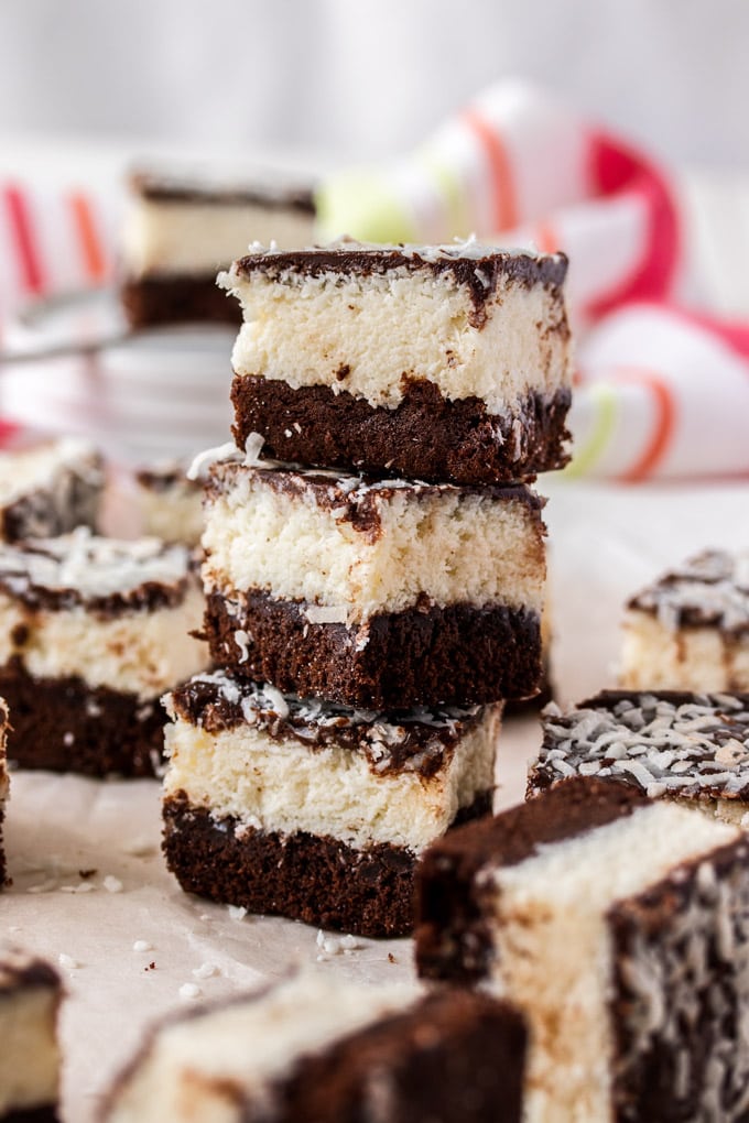 A stack of 3 coconut brownies with others around it