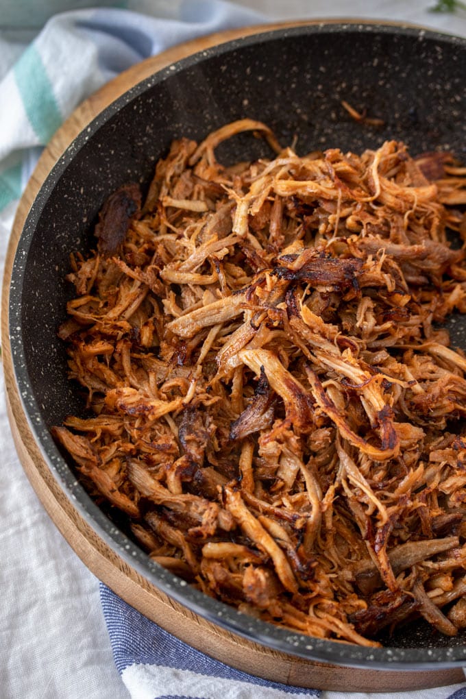 A birdseye view of a frying pan filled with BBQ pulled pork