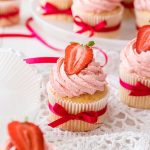 These easy Vanilla Cupcakes take no time at all to mix together. These moist and fluffy cupcakes are topped with a Strawberry Buttercream.