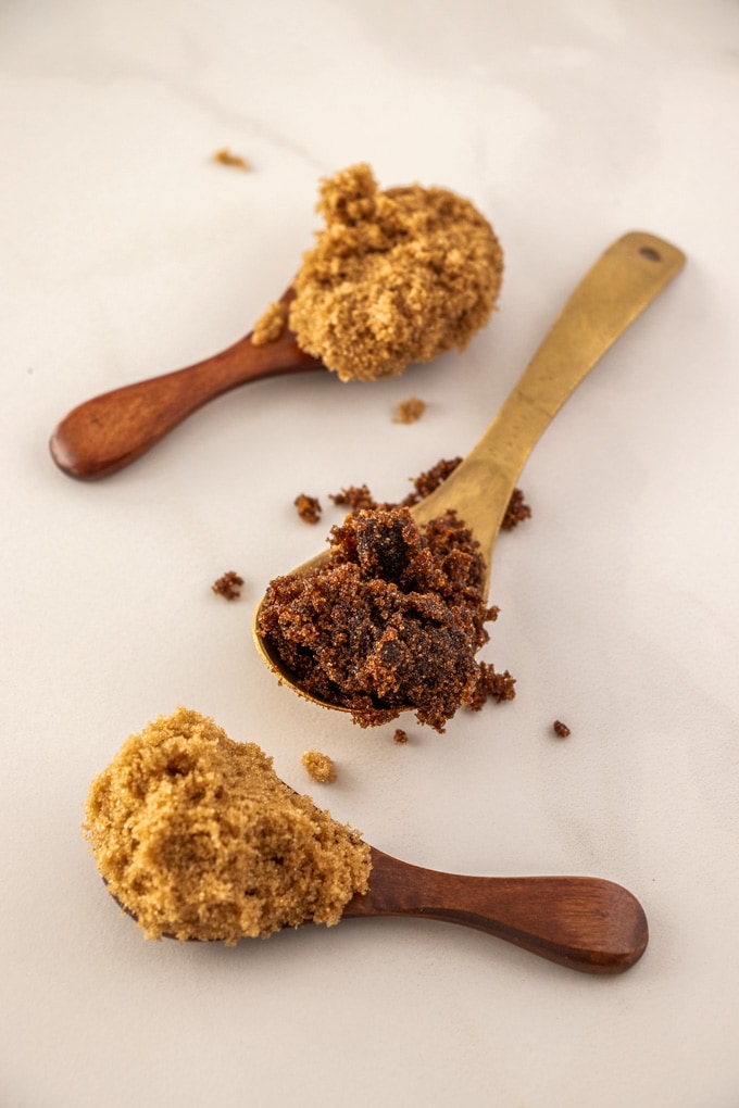 Three spoons with different types of brown sugar