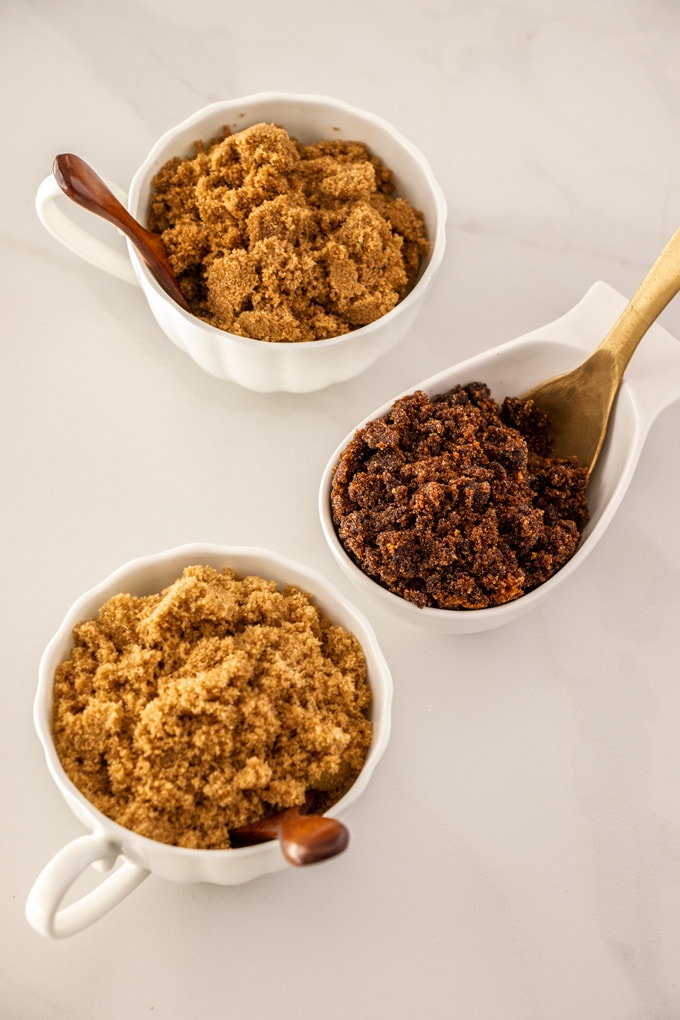 Three bowls with different types of brown sugar
