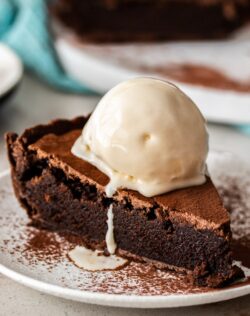 A close up of brownie pie witha scoop of ice cream on top