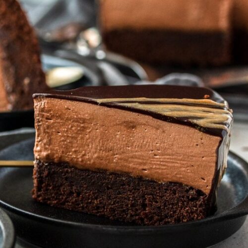 A closeup of chocolate mousse mud cake with the rest in the background