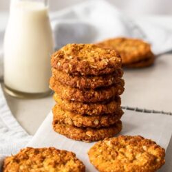 A stack of Anzac Biscuits on a wire rack