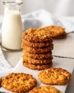 A stack of Anzac Biscuits on a wire rack