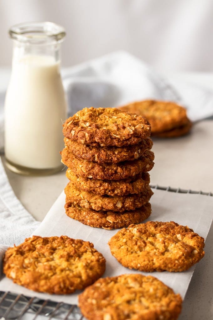A stack of Anzac Biscuits on a wire rack.