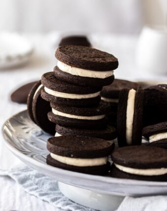 A stack of homemade oreo cookies on a grey plate